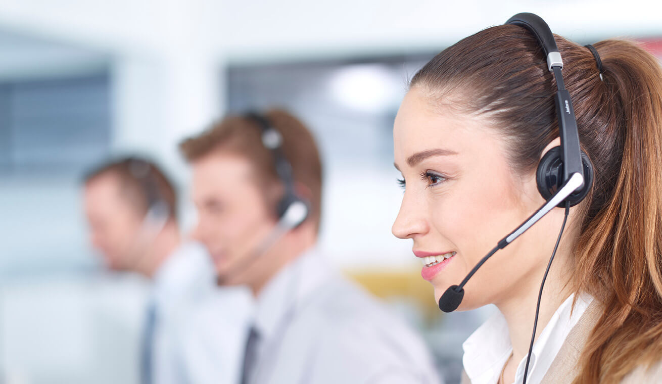 Image of three call centre agents talking with headphones